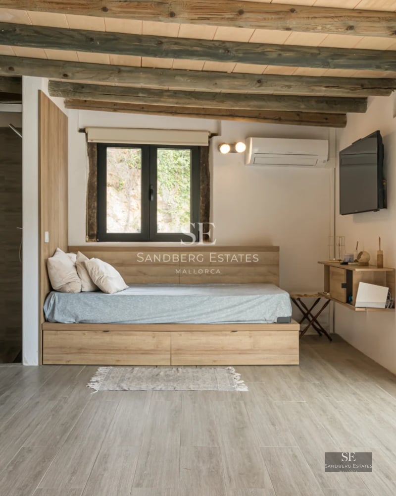 Exterior view of a modern villa with a pool, lush garden, and large windows offering natural light.