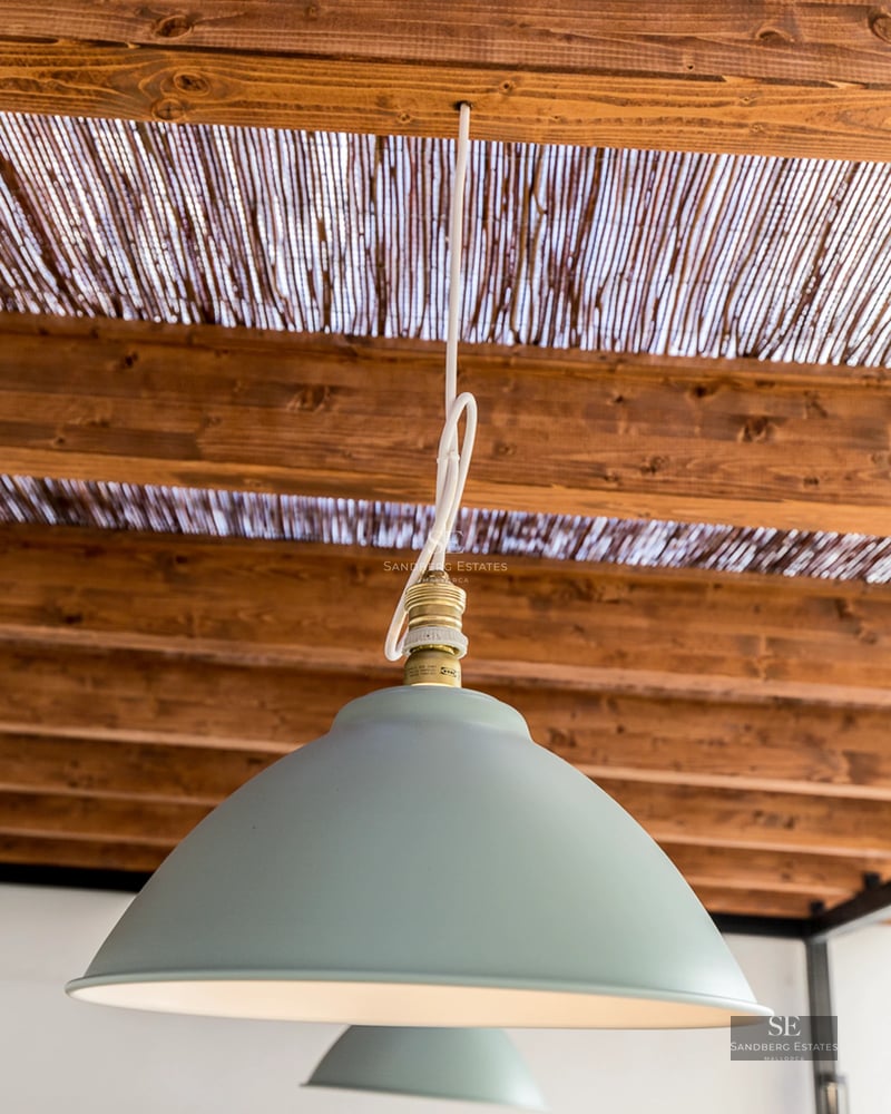 View of the pool and terrace with sun loungers. Modern architecture with large windows and lush vegetation. Luxurious exterior design.