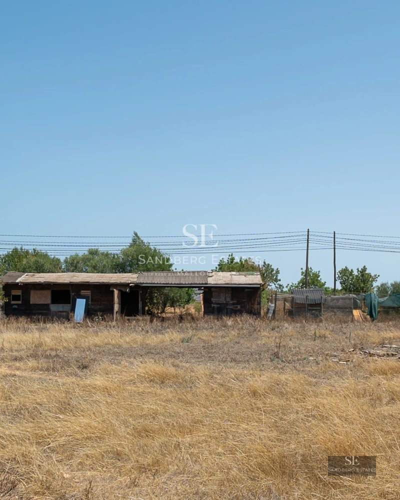 Large balcony with sea view, glass railing, modern furniture. Bright and minimalist interior visible.