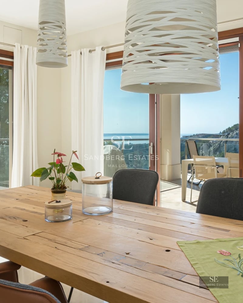 Exterior view of a modern villa with infinity pool, outdoor living area, and sea view. Sleek and minimalist design.