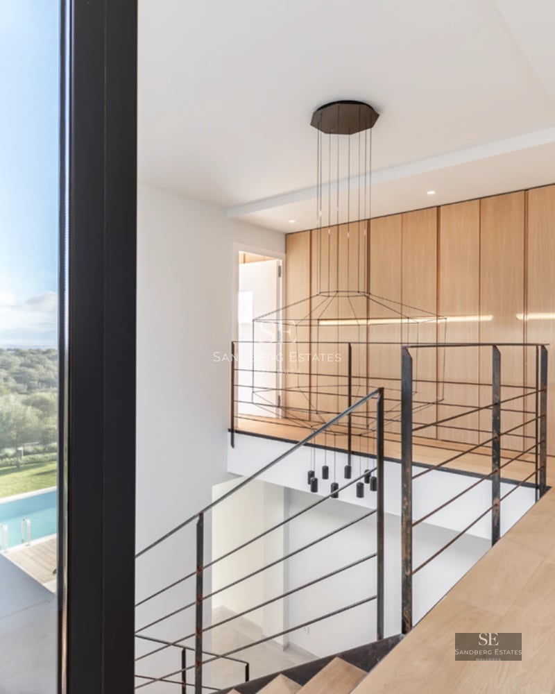 Expansive terrace with pool, sun loungers, and panoramic views. Modern design featuring clean lines and abundant natural light.