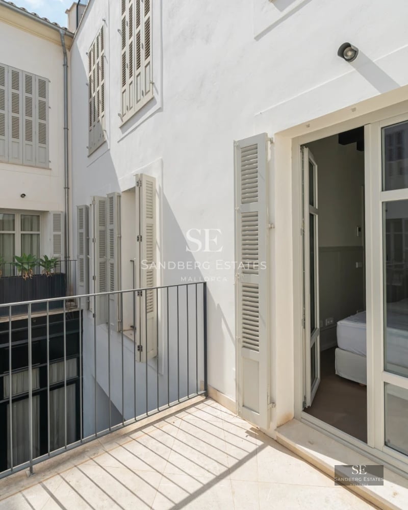 Exterior view of a modern villa with a pool, manicured garden, and minimalist architecture featuring large windows.