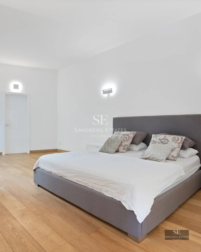 Exterior view of a modern villa with infinity pool, manicured garden, and expansive terraces. Minimalist architecture with large windows.