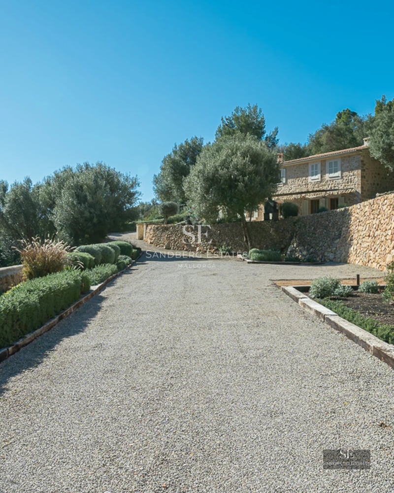 Spacious balcony with panoramic sea views. Glass railing, wooden floors, and modern furniture. Warm lighting and relaxing atmosphere.