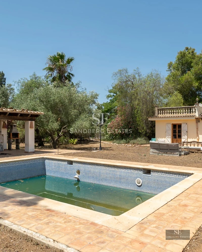 Spacious terrace with pool, sun loungers, and sea view. Modern design featuring a white facade and large windows.