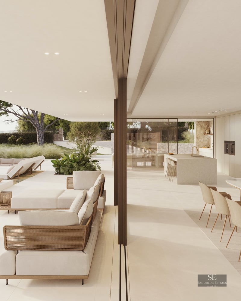 Modern luxury terrace with white lounge furniture and a pool next to an open-plan indoor dining area.
