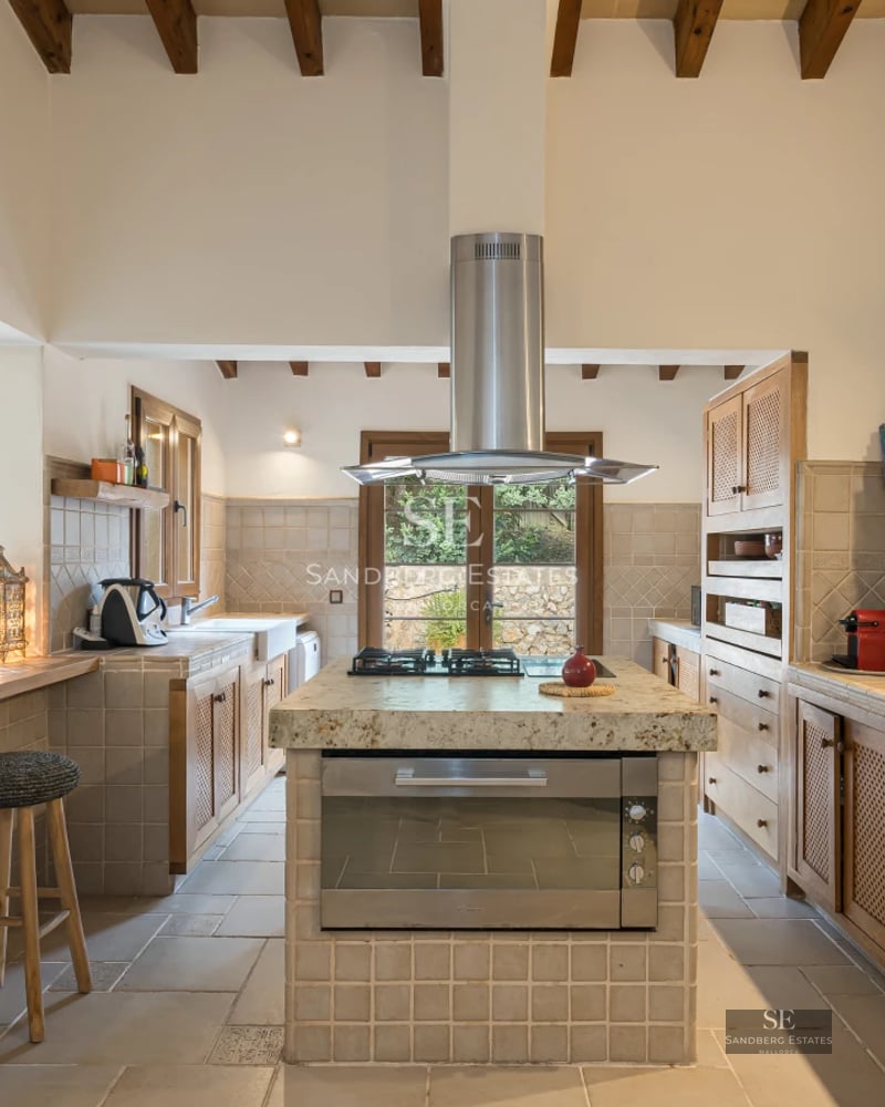 Spacious balcony with glass railing, wooden floor, and panoramic ocean view. Modern design with elegant furniture.