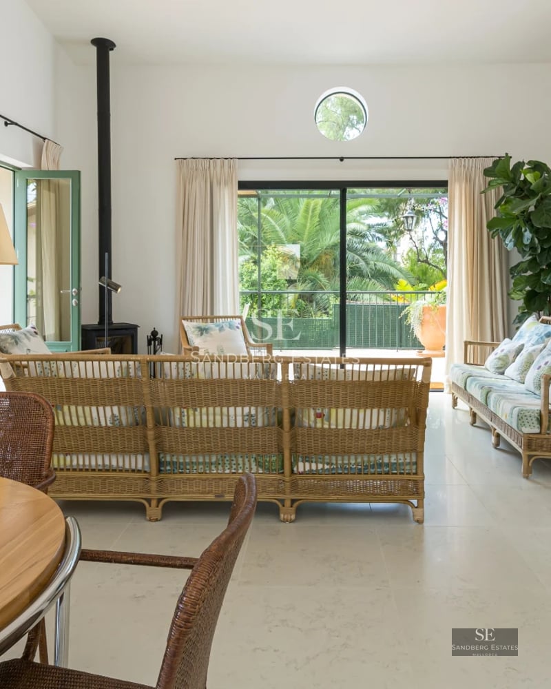 Exterior view of a modern villa with infinity pool, landscaped garden, and spacious terraces. Minimalist architecture with large windows.