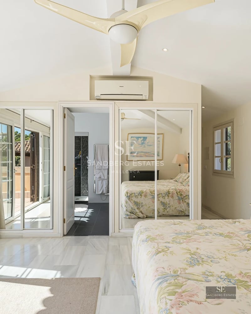 Spacious living room with picture windows, sea view, light wood floors, modern sofas, and terrace access. Minimalist and bright design.