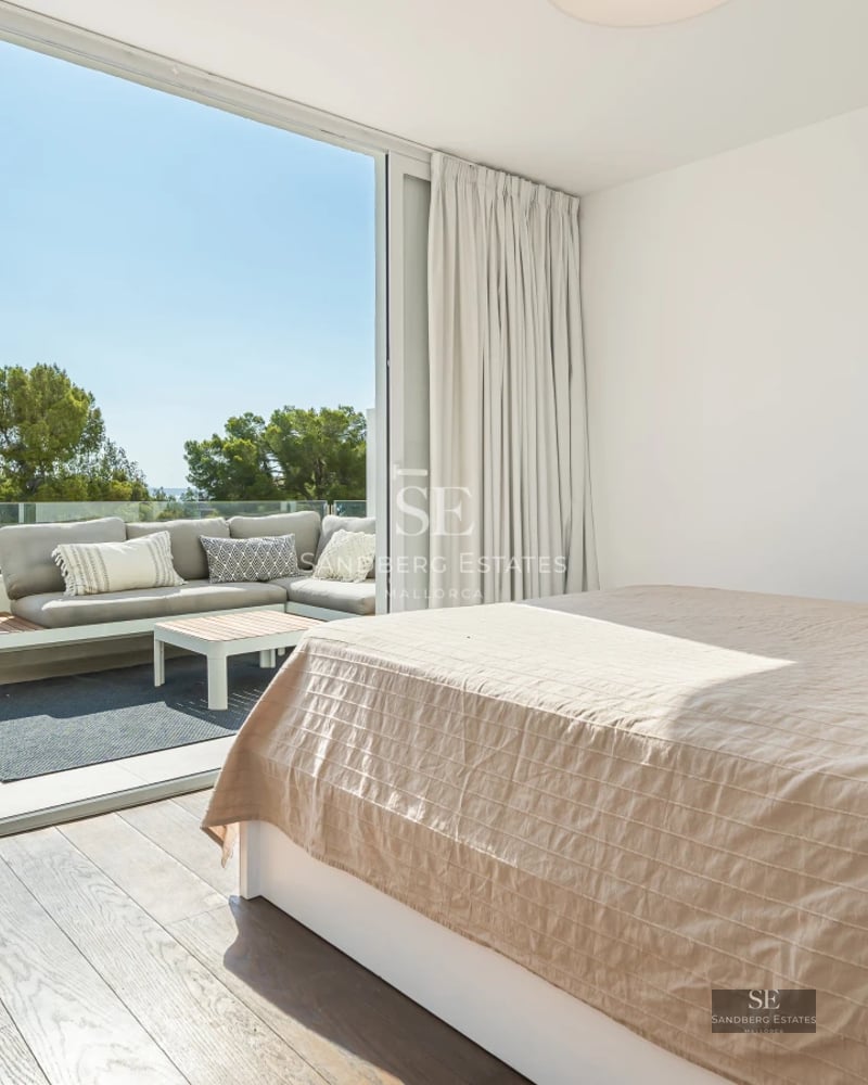 Expansive terrace featuring an infinity pool, panoramic sea views, modern and elegant furniture. Minimalist design with abundant natural light.