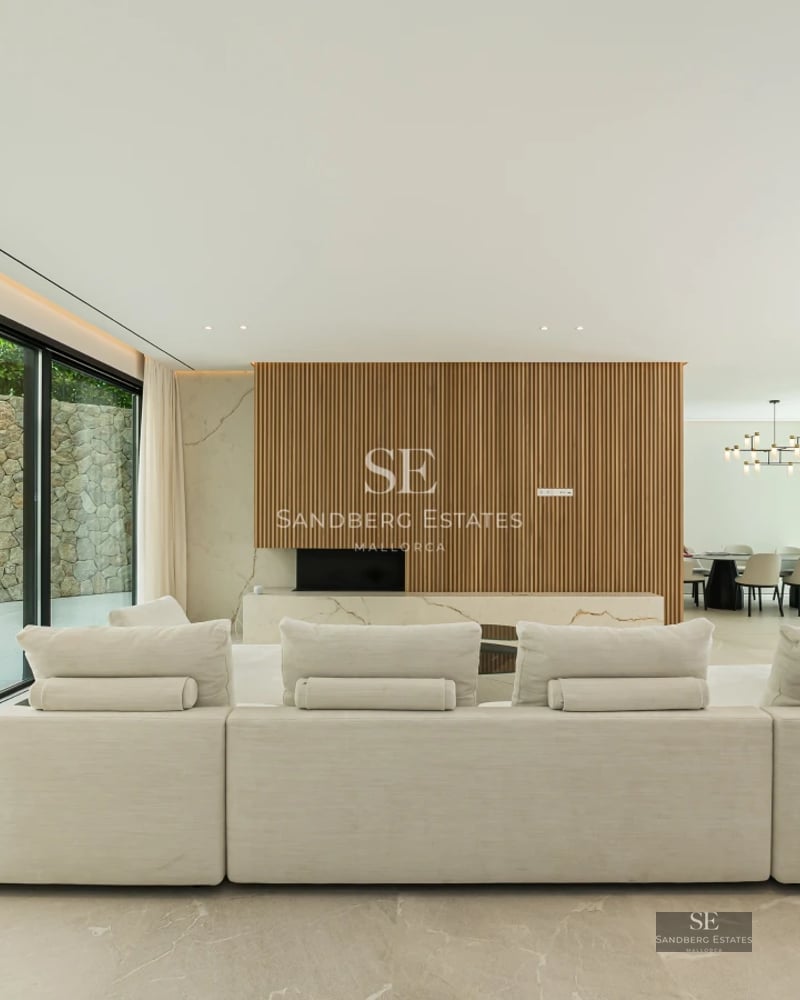 Spacious terrace with infinity pool, sun loungers, sea views. Modern, minimalist design with white walls and abundant natural light.