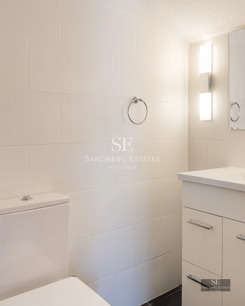 Exterior view of modern villa with reflecting pool, minimalist design, and expansive green spaces. Warm ambient lighting.