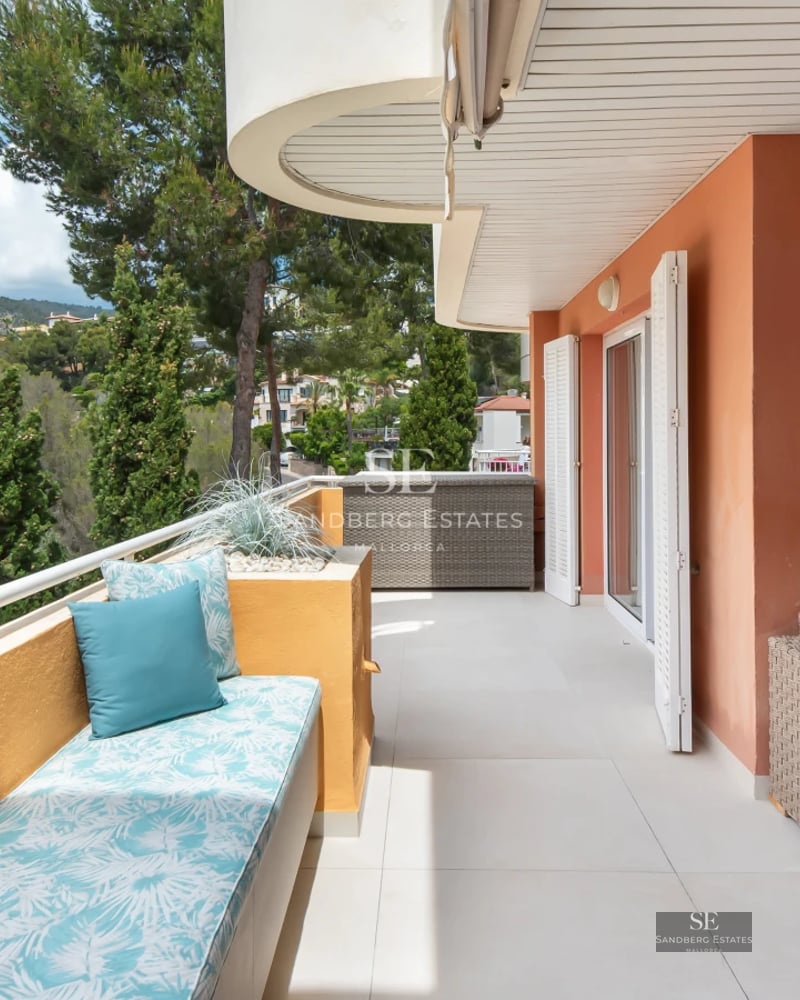 Exterior of a modern villa with reflecting pool, large windows, and lush vegetation. Contemporary architectural design.