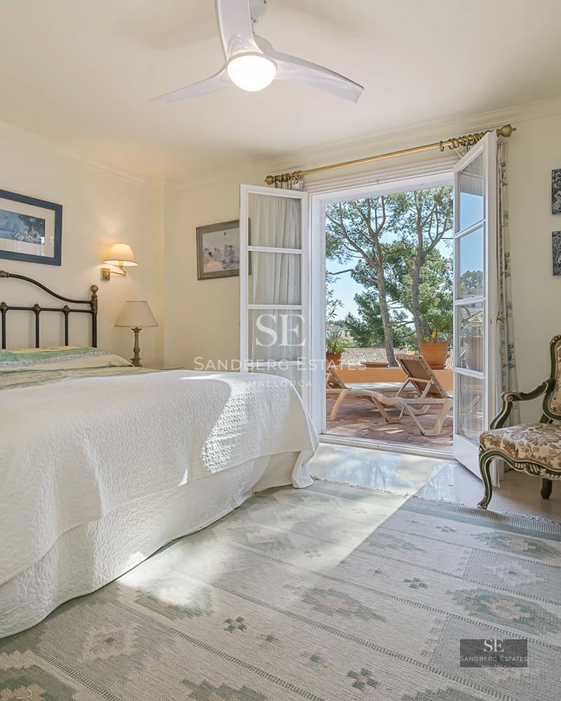 View of modern pool surrounded by lawn and minimalist architecture with large windows and wooden details.