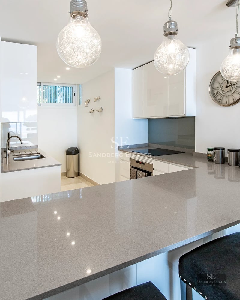 Exterior view of a modern villa with an infinity pool. Minimalist architecture, large windows, and lush landscaping.