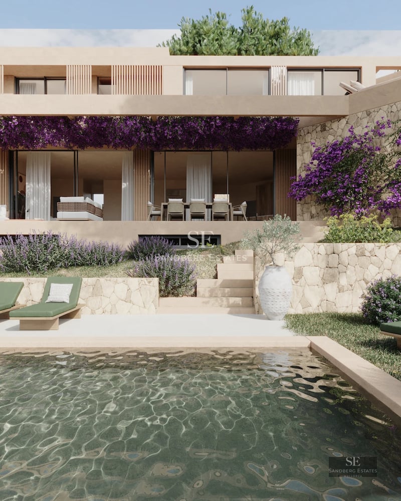 Spacious living room featuring large windows, modern sofas, and access to a terrace with views. Elegant and bright design.