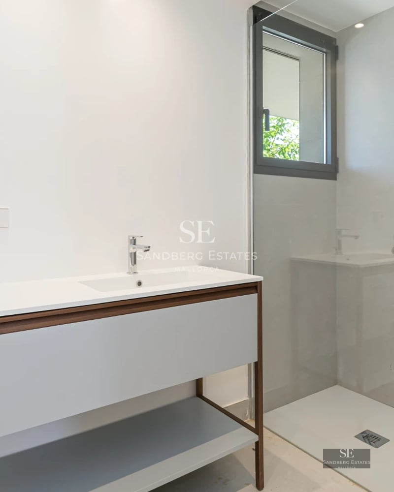 Exterior view of a modern villa with infinity pool, lush garden, and sleek architectural design. Spacious and bright living spaces.