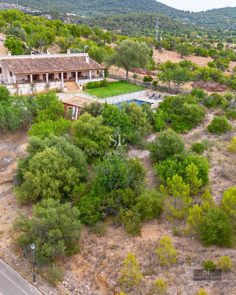 Bright living room with large windows, sea view, modern furniture, and balcony access. Light wood flooring.