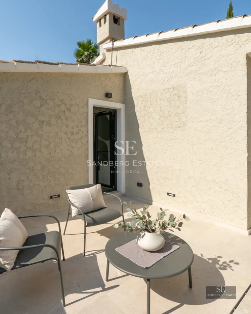 Spacious living room featuring floor-to-ceiling windows, a modern fireplace, and minimalist design. Panoramic views and natural light.