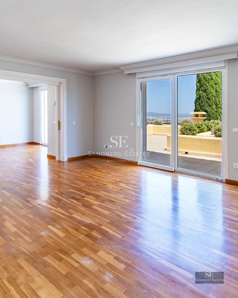 Exterior view of a modern villa with a pool, manicured garden, and minimalist architecture. Large windows and terraces.