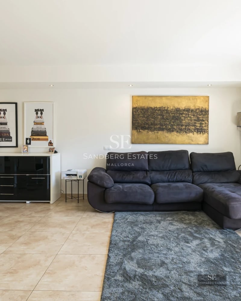 Villa view featuring infinity pool, sun loungers, and lush vegetation. Modern architecture with large windows and terrace. Relaxing landscape.