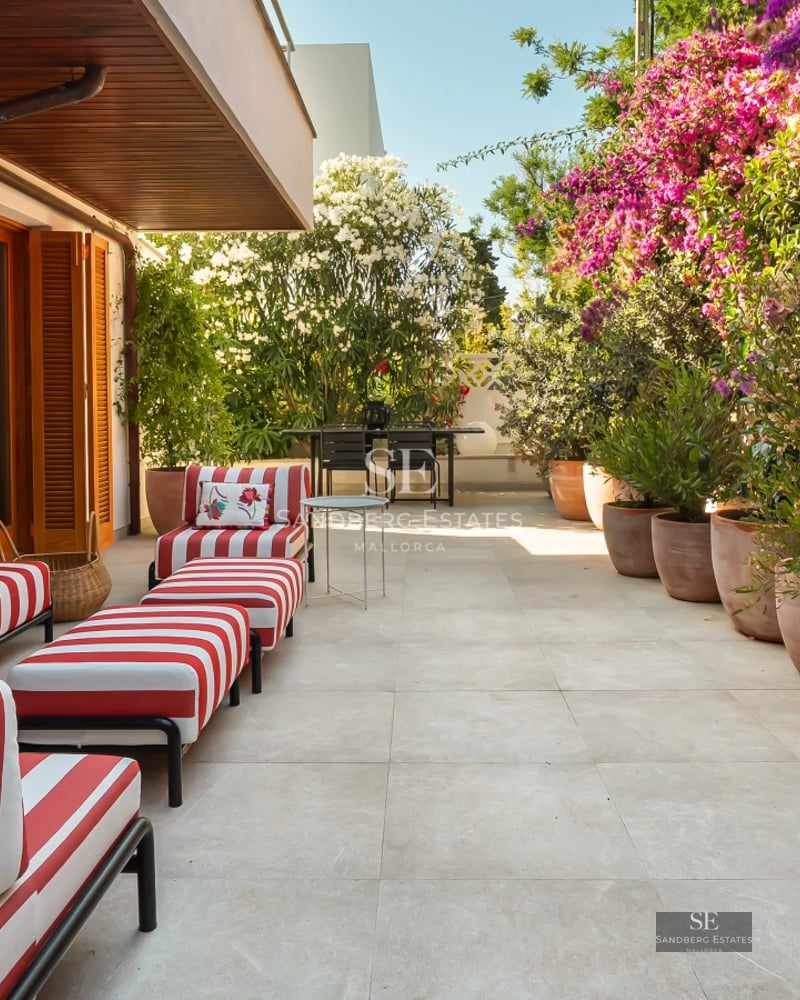 Spacious living room with large windows, modern fireplace and elegant furniture. Panoramic outdoor views.