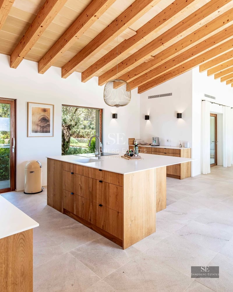 Exterior view of a modern villa featuring a pool, lush garden, and spacious terraces. Minimalist architecture with clean lines and large windows.