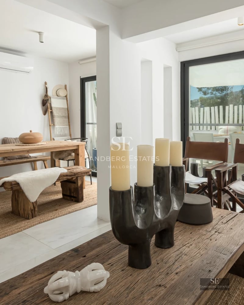 Exterior view of a luxurious villa featuring a pool, lush garden, and modern architecture. Warm lighting and large windows.