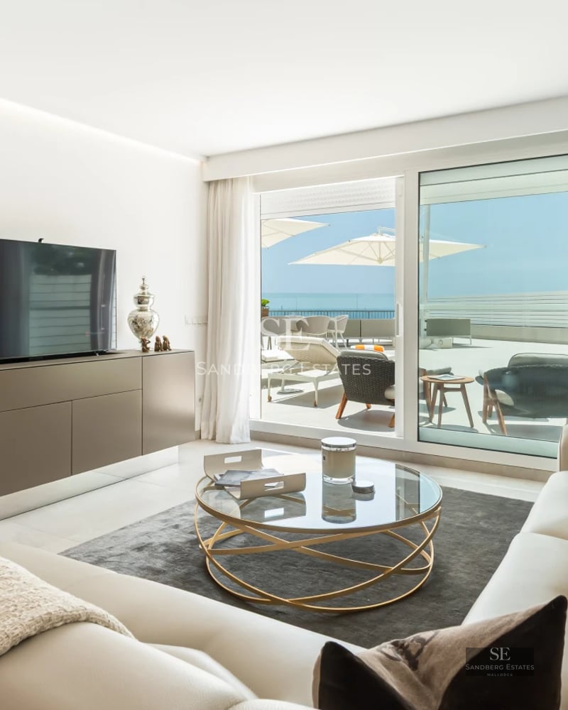 Spacious living room with panoramic sea views, light wood floors, and modern design. Abundant natural lighting.