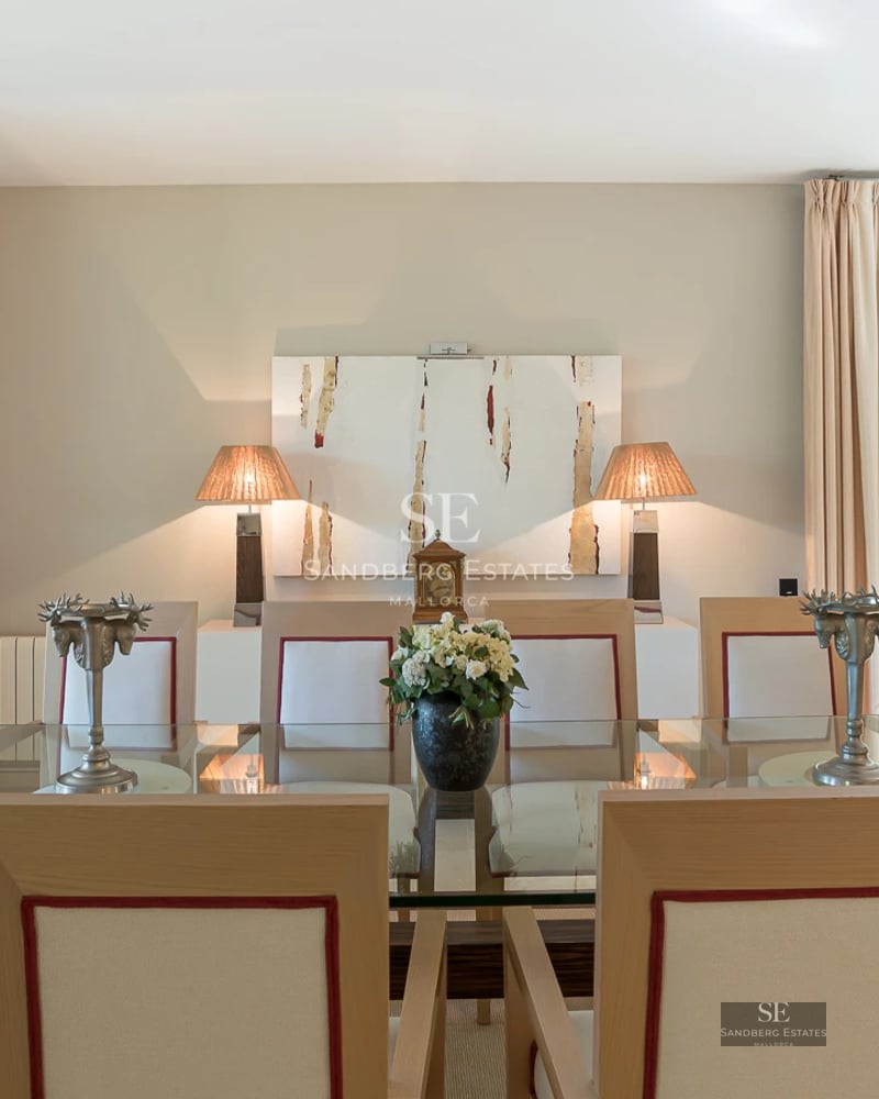 Spacious living room featuring panoramic windows, light wood flooring, modern furniture, and breathtaking ocean views.