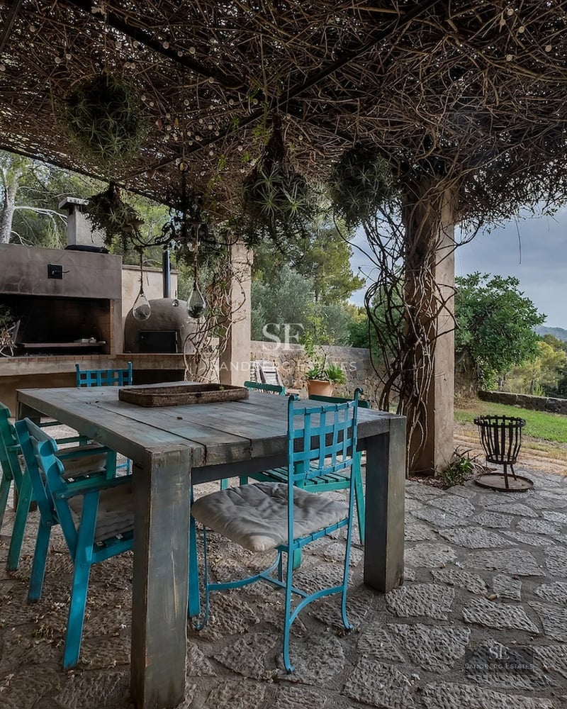 Spacious living room with large windows, modern furniture, wood flooring, and panoramic sea views. Abundant natural light.