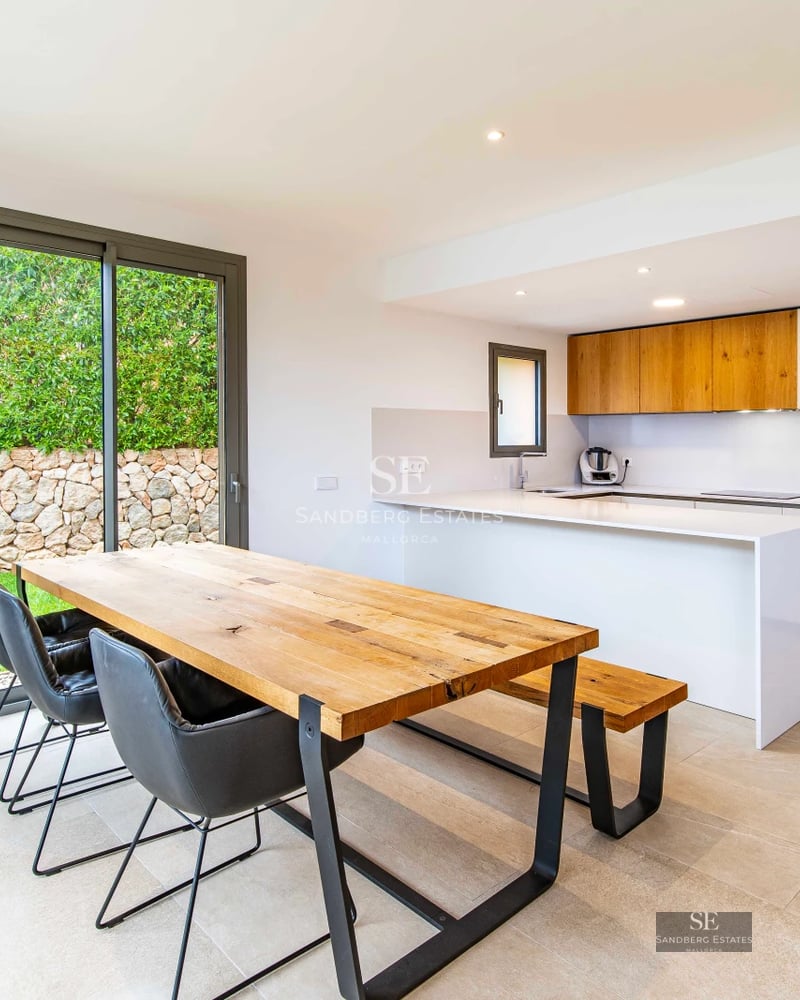 Spacious living room with panoramic sea view windows, modern and elegant decor featuring a fireplace and designer furniture.