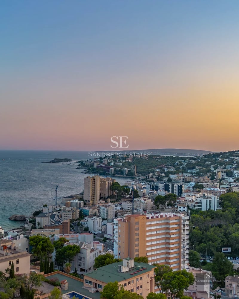 Exterior view of a modern villa featuring an infinity pool, garden, and spacious terraces. Minimalist design with abundant natural light.