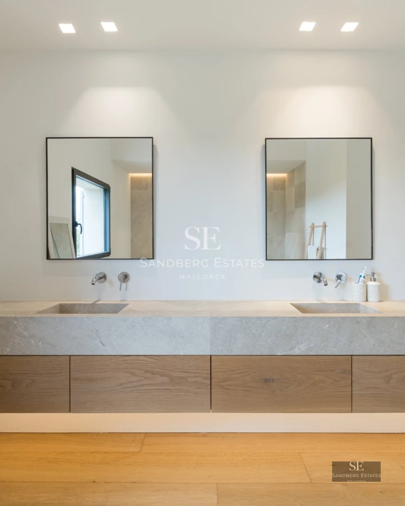 Spacious living room with large windows overlooking the pool. Modern design, natural light, and elegant furniture. Light wood floors and white walls.