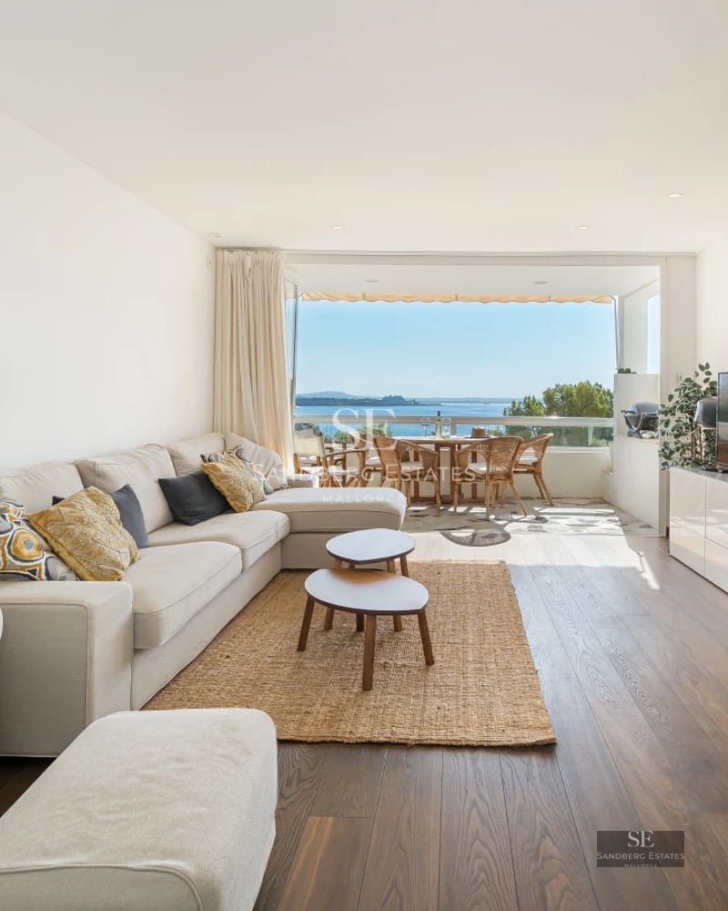 Exterior view of a modern villa featuring an infinity pool, lush garden, and spacious terraces. Minimalist architecture with large windows.