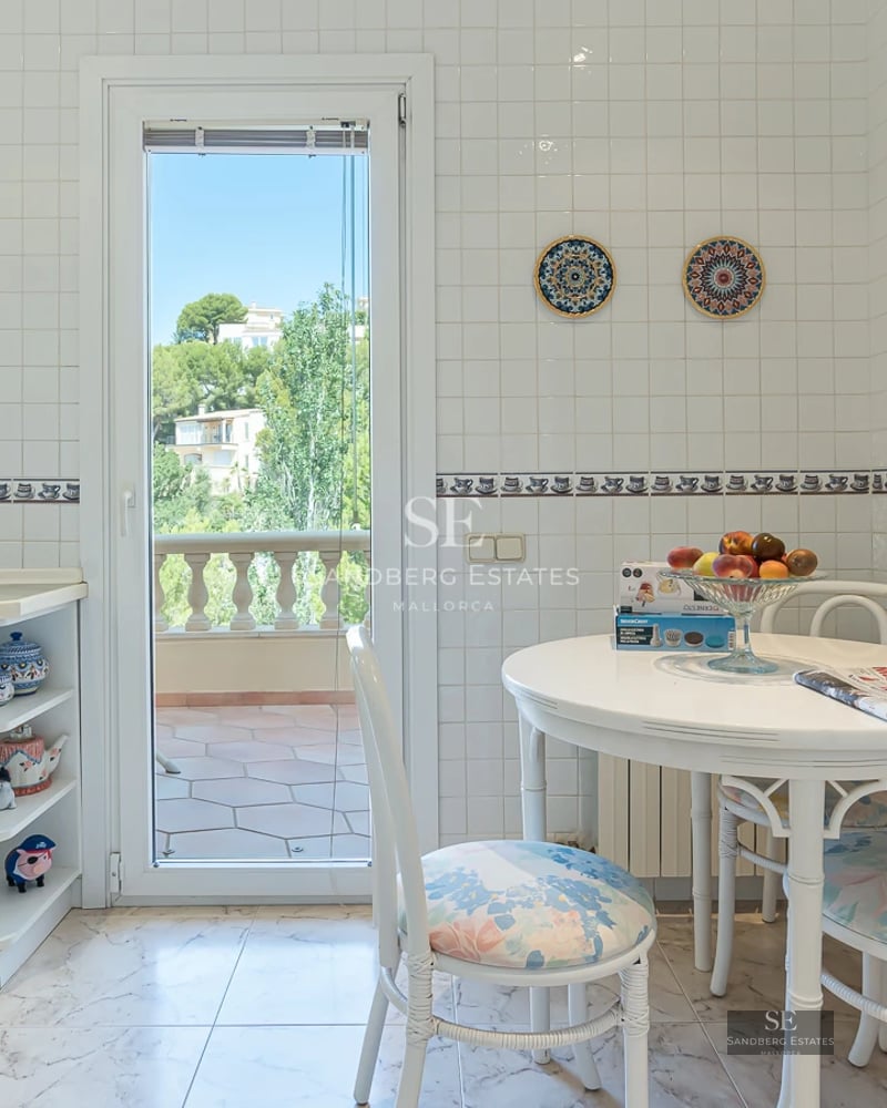 Expansive terrace with infinity pool, sun loungers, ocean views, and lush greenery. Modern design with clean lines and natural materials.