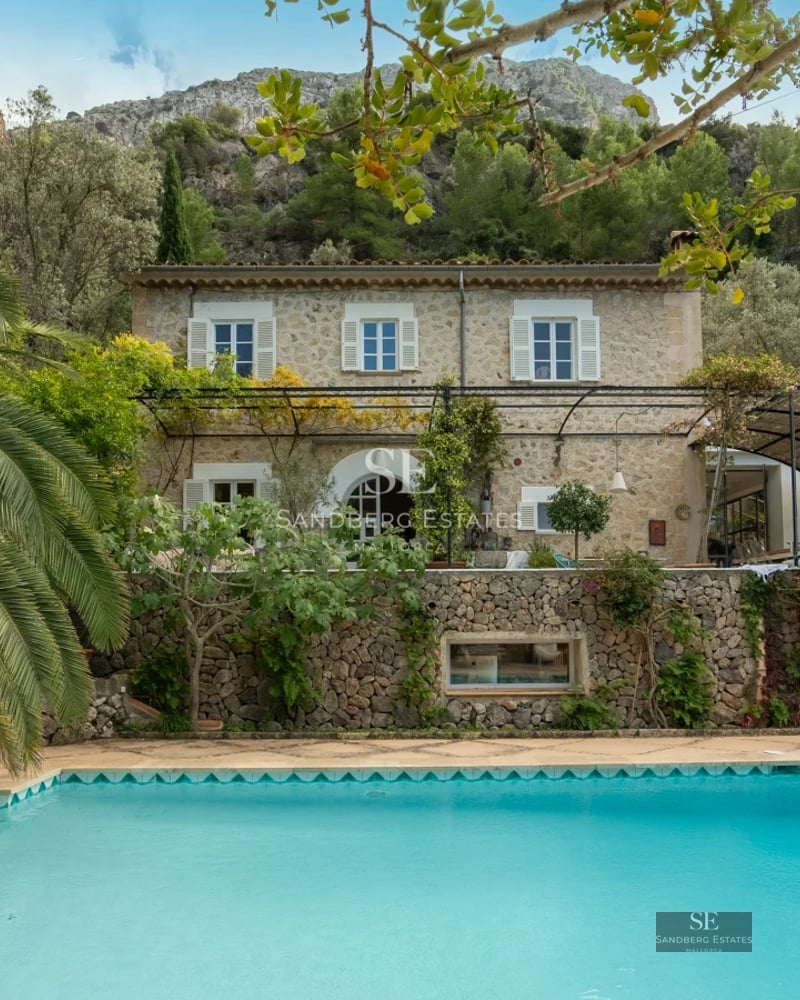 Bright living room with balcony and sea view. Modern interior with light wood floors and elegant furniture.