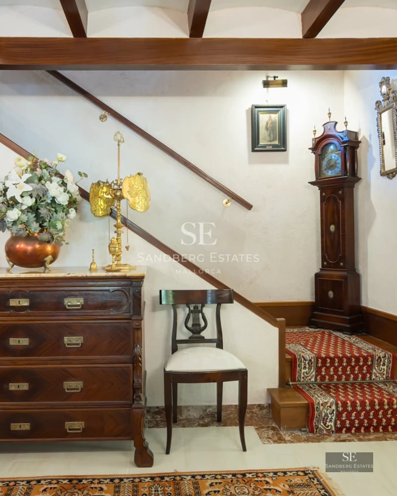 Spacious balcony with sea view, pool, and modern furniture. Designer lighting fixtures and lush greenery.