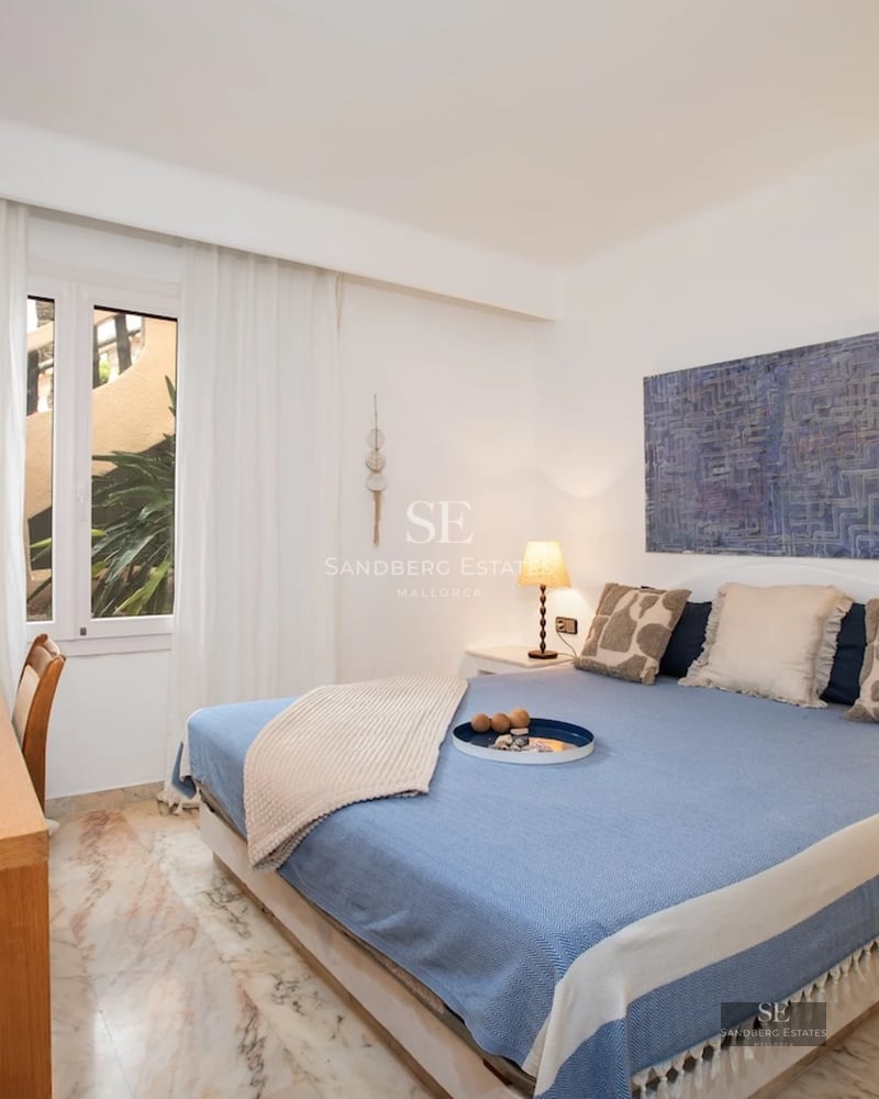 Spacious living room with panoramic windows, fireplace, and modern décor. Breathtaking sea views. Abundant natural lighting.