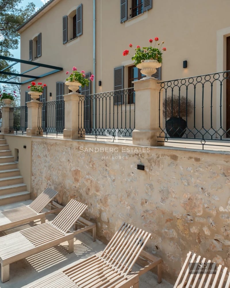 Bright living room with panoramic windows, light wood floors & modern designer furniture overlooking the Mediterranean Sea.