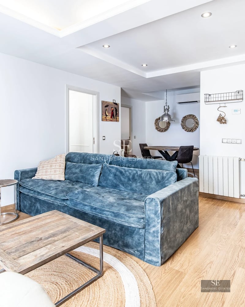 View of a modern infinity pool with breathtaking views. Minimalist design with wooden deck and elegant sun loungers.