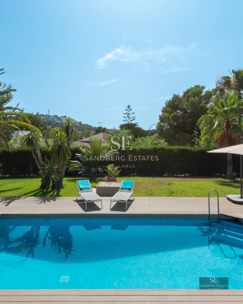 Spacious living room with panoramic windows, infinity pool, and sweeping ocean views. Modern interior with designer furniture.