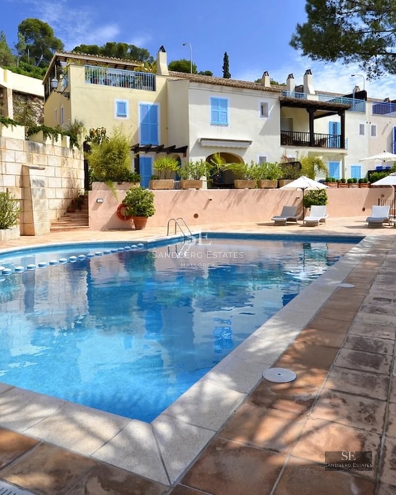 Spacious terrace with a view. Modern and stylish furniture, wood flooring, ambient lighting, and lush greenery.