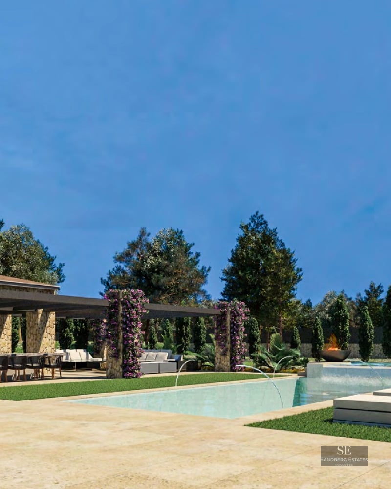 Modern swimming pool with stone architecture, purple flowers, fire pits, and lounge chairs under a clear blue sky.