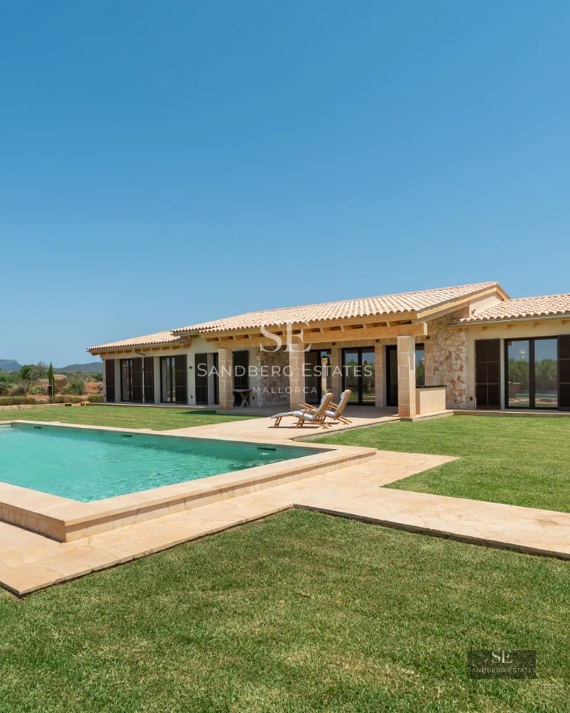 Spacious living room with panoramic sea views. Leather sofas, designer rug, warm lighting, and luxurious details.