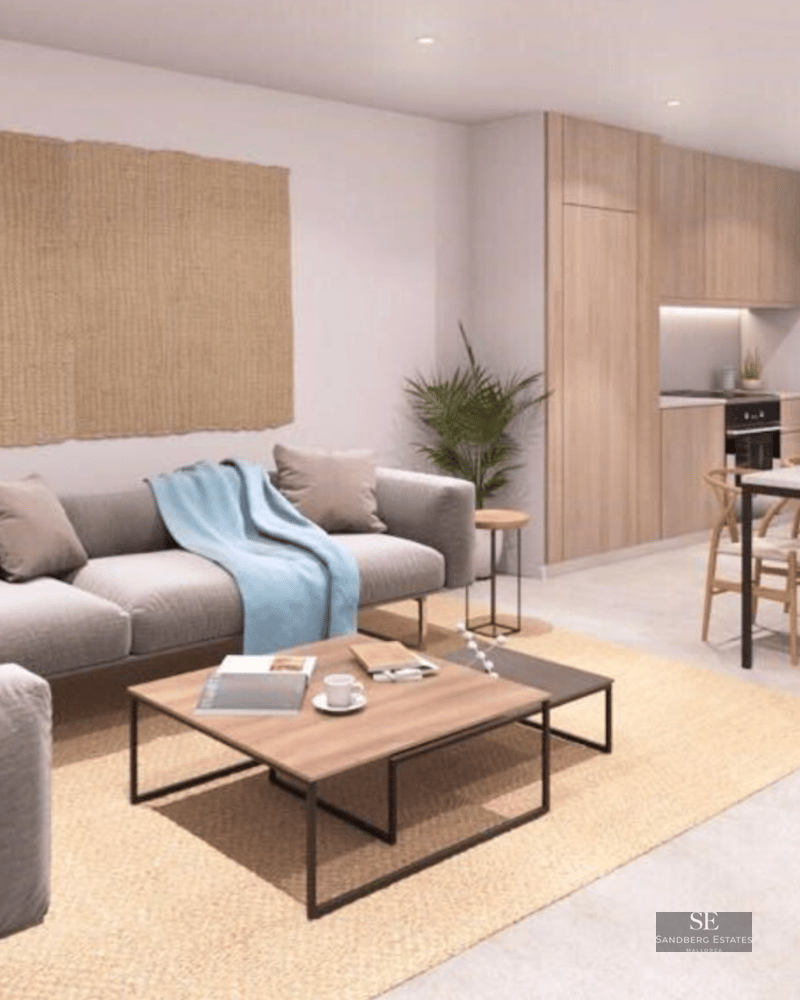 Contemporary living room featuring a grey sofa, wooden dining table, and integrated light wood kitchen.