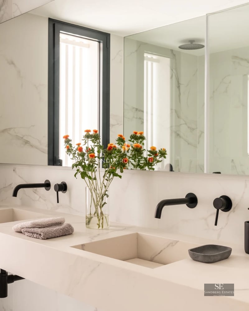 Bright living room with large windows and panoramic sea views. Modern design, elegant furniture, and neutral color palette.