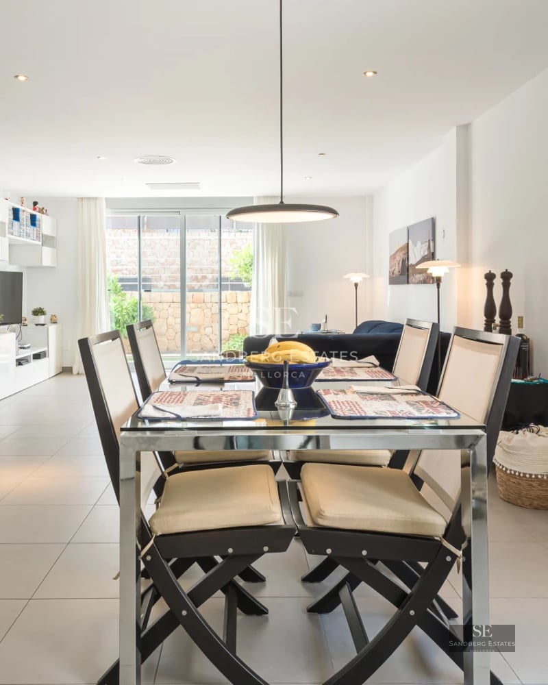 Exterior view of a modern house featuring a swimming pool, manicured lawn, and minimalist architecture. Bright and elegant design.
