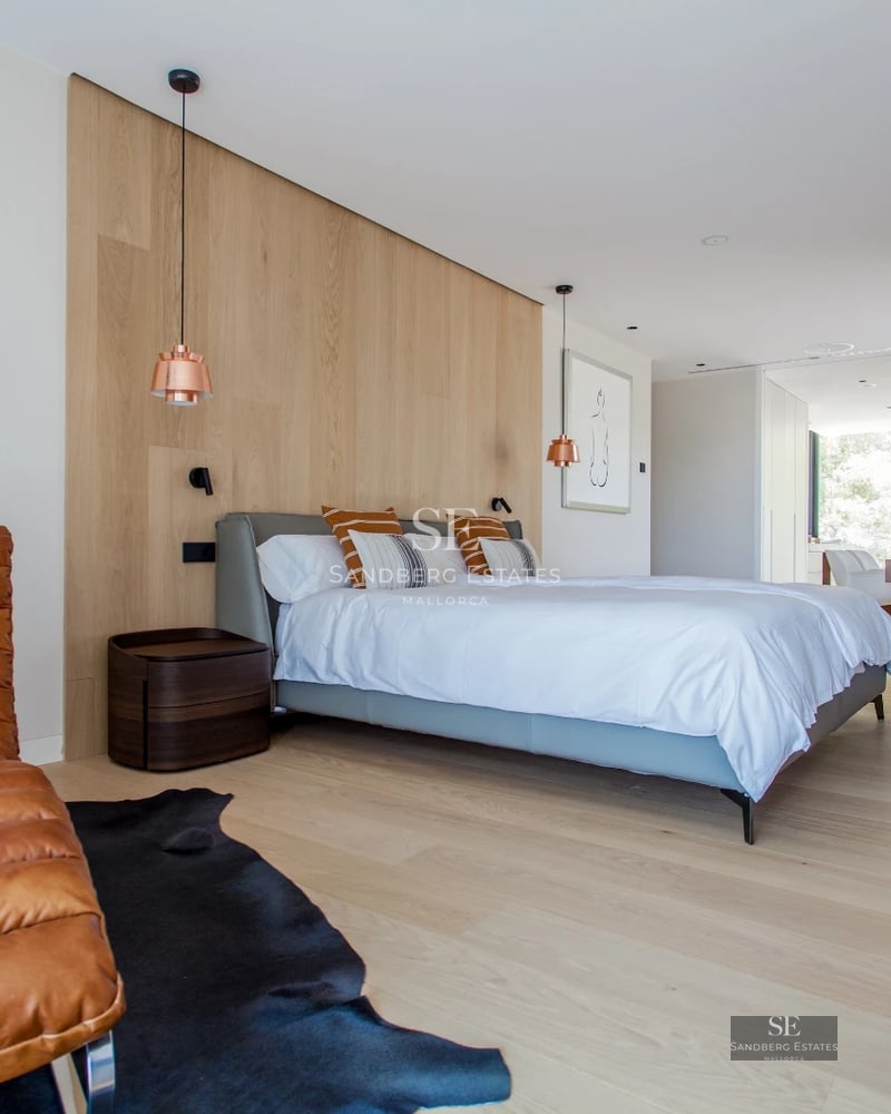 Spacious terrace with pool and sea view. Modern design with glass railing and elegant furniture. Ambient lighting.