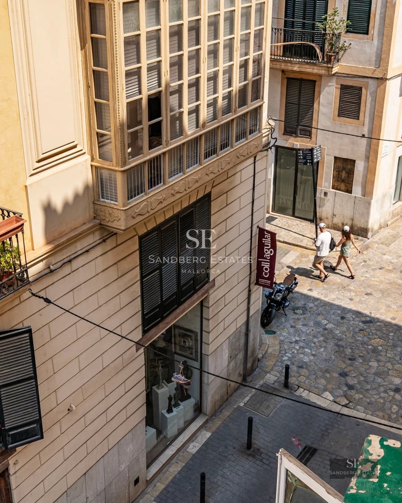 Exterior of a modern villa with a pool, large windows, minimalist design, and lush surrounding vegetation.